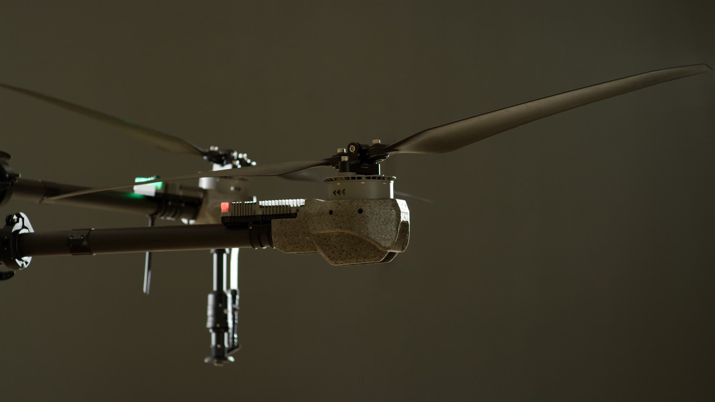 Terraplex I-19 spray drone in profile against a dark studio background